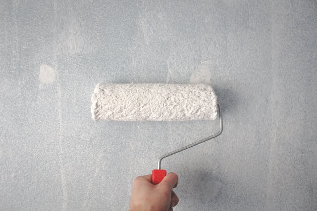 a paint roller with white paint on it
